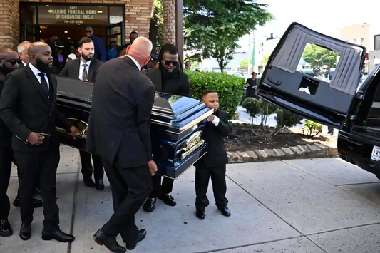 The slain guard’s son, Ralandy Lucien Etienne, was among the pallbearers who helped carry Aland Etienne’s casket to the black hearse for the final journey in a life that brought him from Haiti to the United States.