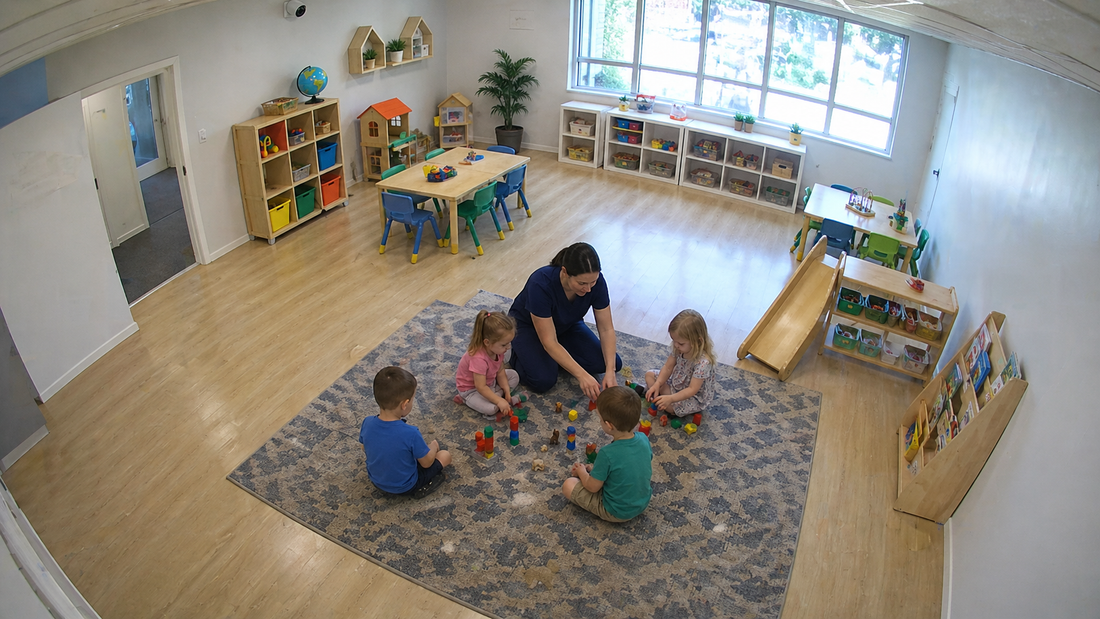CCTV point-of-view of a preschool classroom with children and a caregiver, highlighting daycare security, childcare safety, and classroom video monitoring.