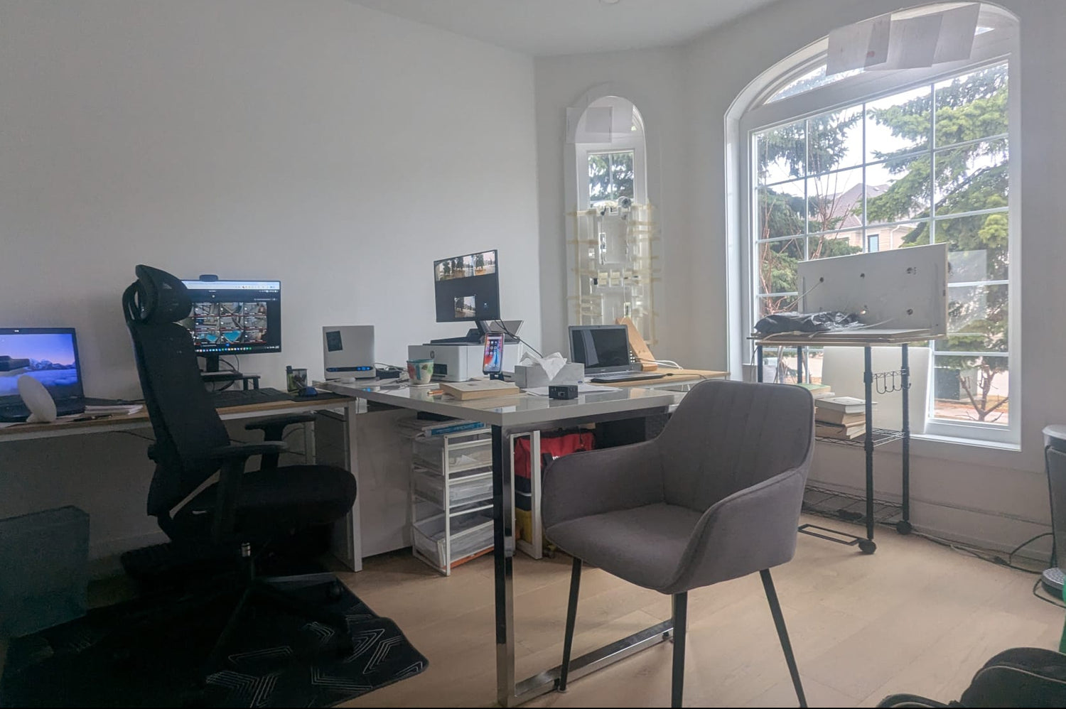 Modern office setup with a desk, chair, and computer monitors.